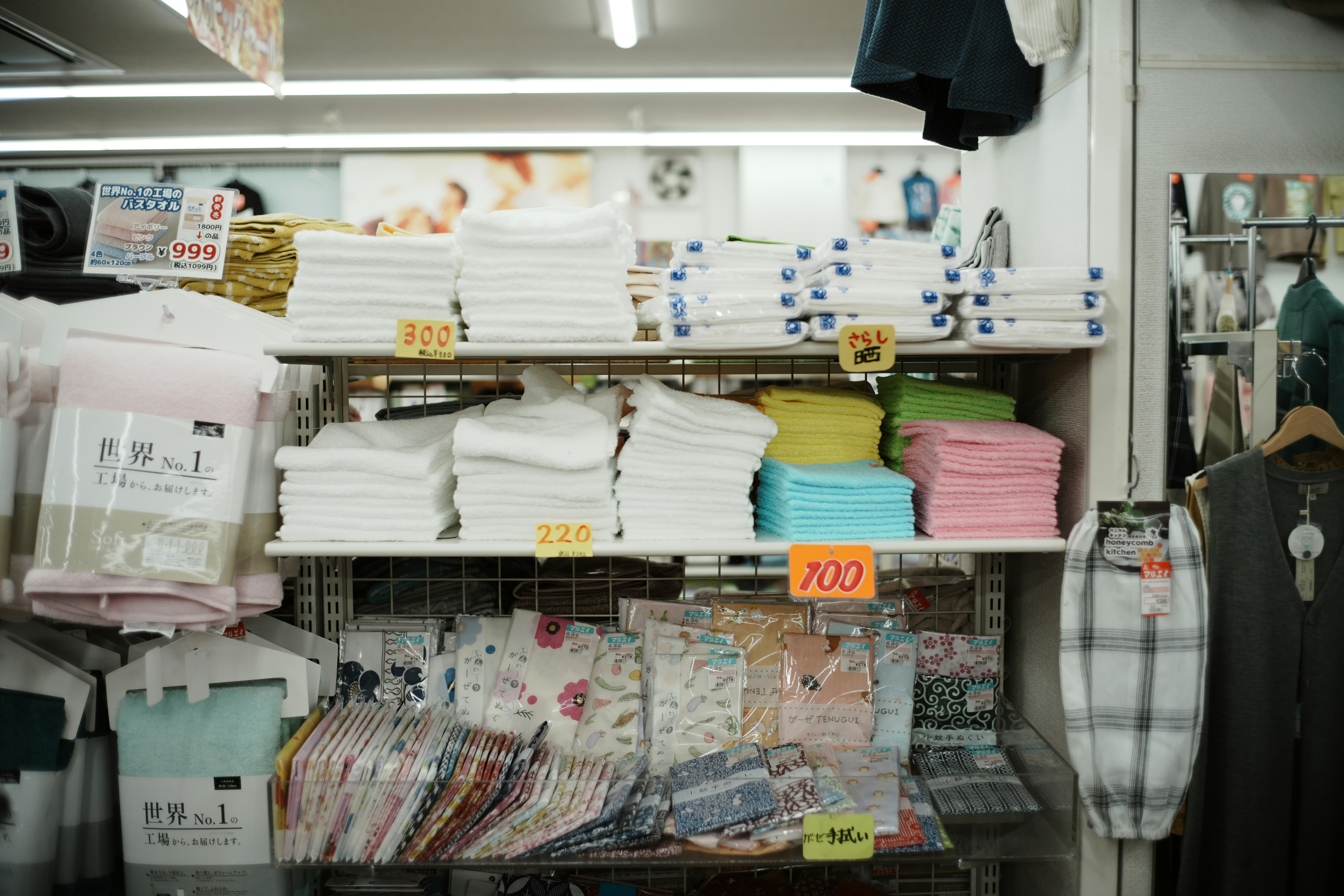 A clothes store with stacks of T-shirts
